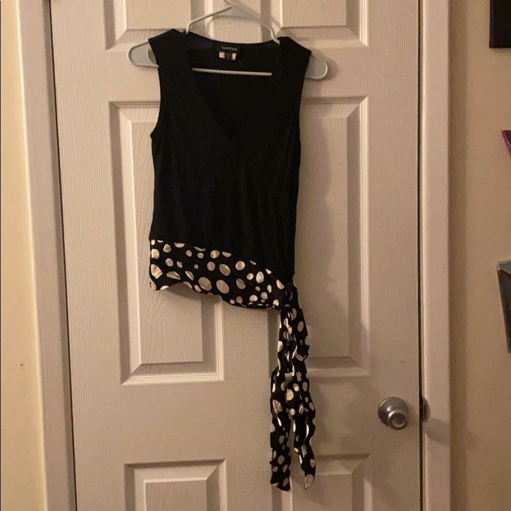 A black and white polkadot top with bow tie